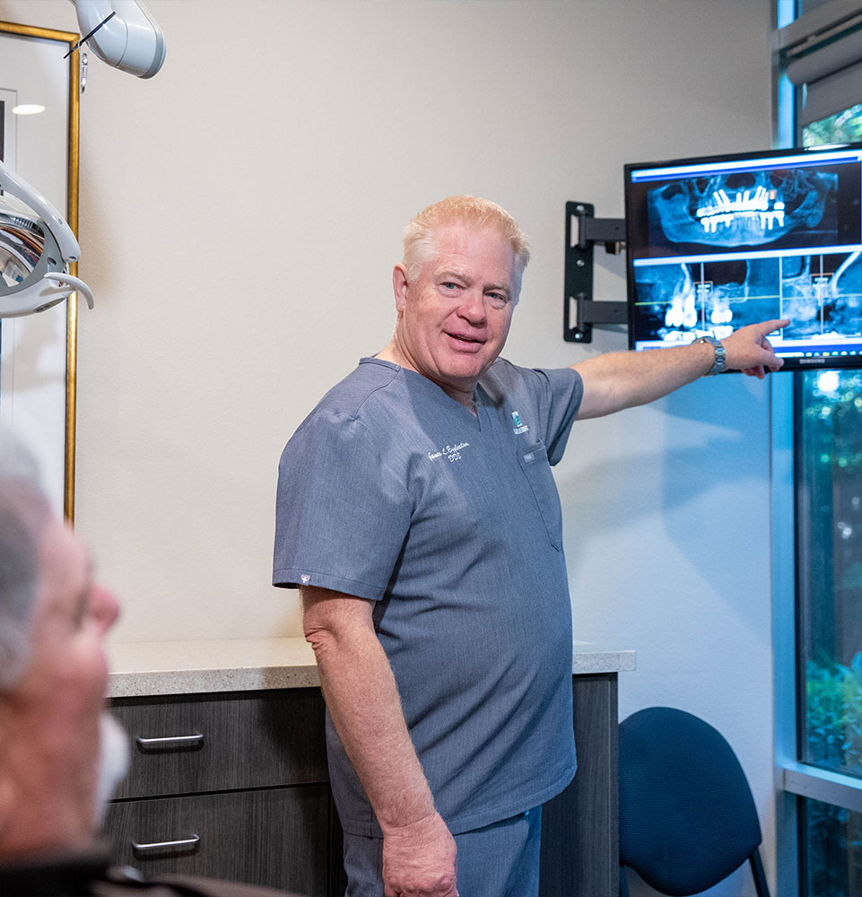 Dr. Eggleston explaining 3D dental implant imaging to a patient
